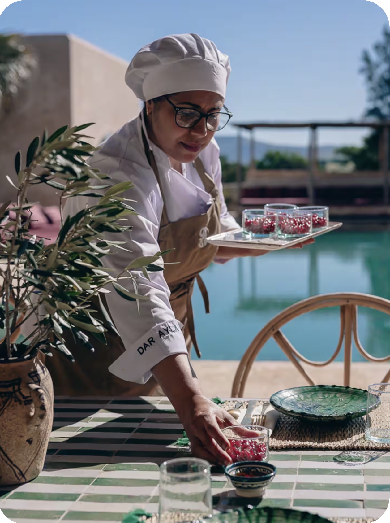 Private chef plating food by the pool